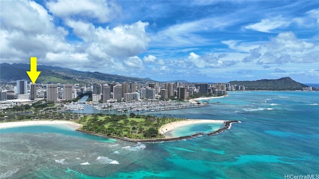 aerial view with a water and mountain view and a beach view