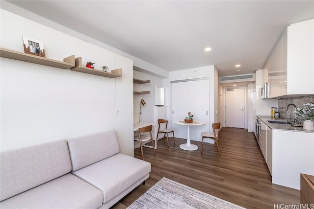 living room with sink and dark hardwood / wood-style flooring