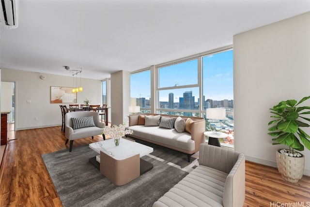 living room with a wall unit AC, dark hardwood / wood-style floors, and plenty of natural light