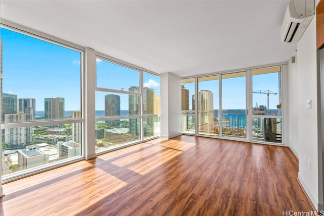 unfurnished sunroom with a wall unit AC