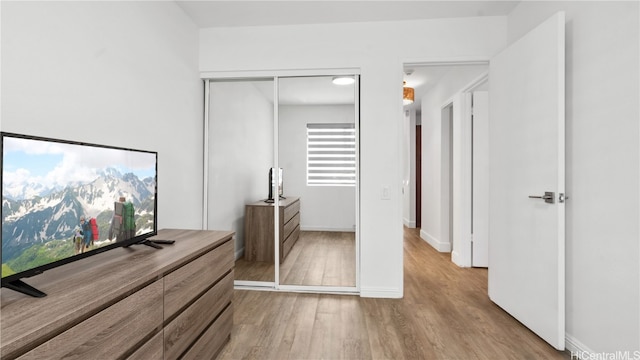 bedroom featuring light hardwood / wood-style flooring and a closet