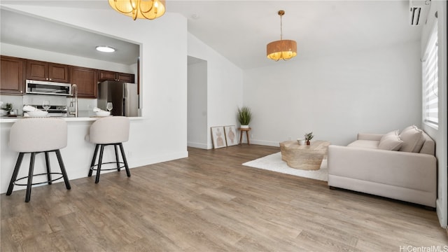 living room featuring light hardwood / wood-style floors and lofted ceiling