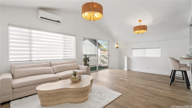 living room with wood-type flooring, vaulted ceiling, and a wall mounted AC