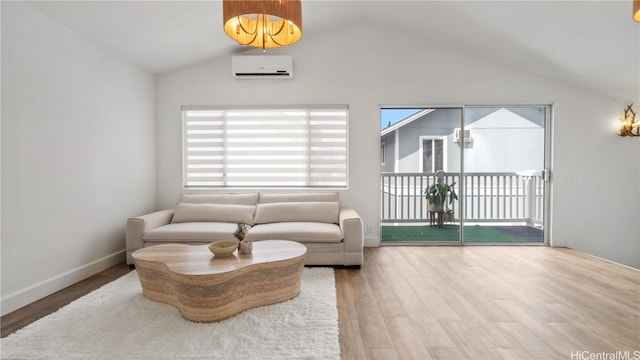 living room with a wall unit AC, lofted ceiling, and hardwood / wood-style flooring