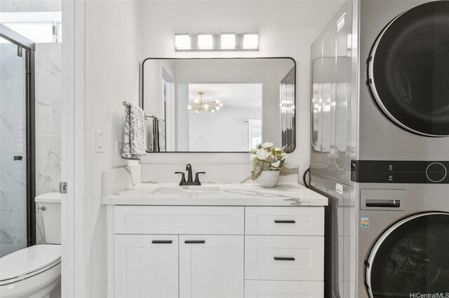 91-1030 Hoopili St Unit 54, Ewa Beach, HI 96706 - laundry room featuring stacked washing machine and dryer and a chandelier