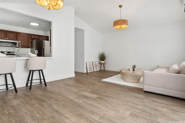 91-1030 Hoopili St Unit 54, Ewa Beach, HI 96706 - living room with lofted ceiling and light wood-style flooring