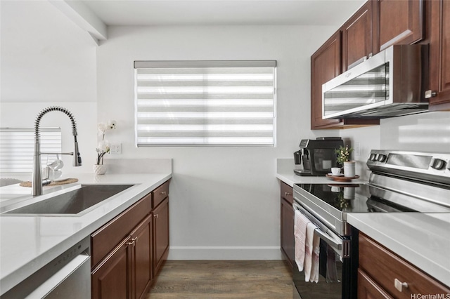 91-1030 Hoopili St Unit 54, Ewa Beach, HI 96706 - kitchen featuring stainless steel appliances, light countertops, and dark wood-style floors