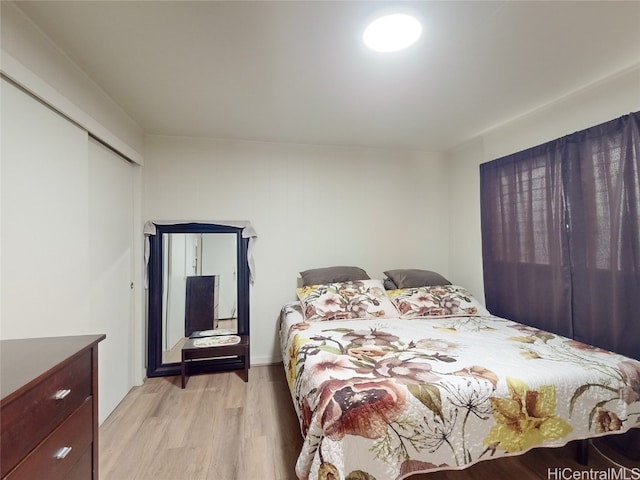 bedroom with a closet and light hardwood / wood-style flooring