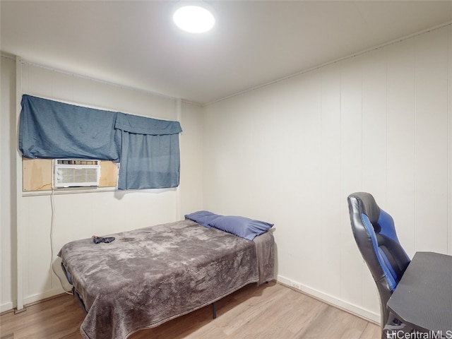 bedroom featuring cooling unit and hardwood / wood-style flooring