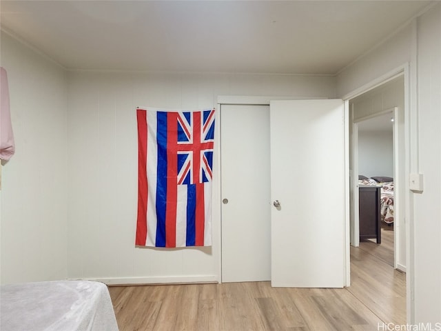 bedroom with a closet and hardwood / wood-style floors