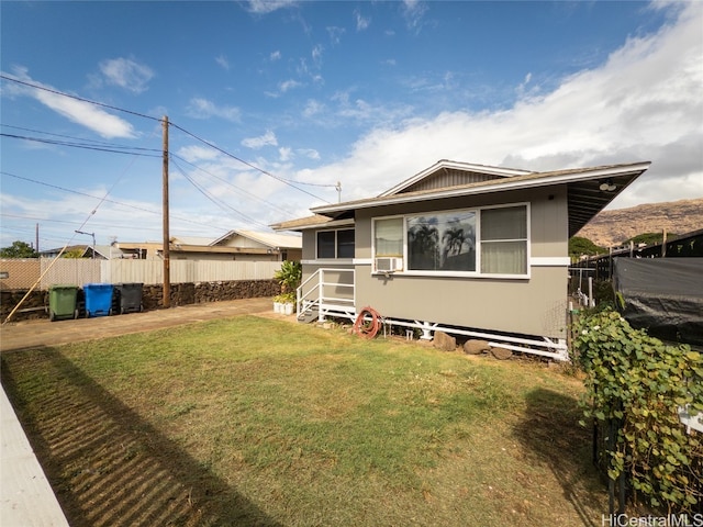 rear view of property with a lawn