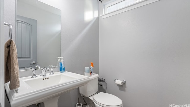 bathroom featuring sink and toilet