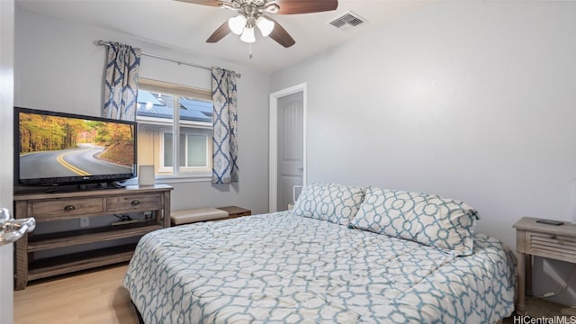 bedroom with ceiling fan and light wood-type flooring