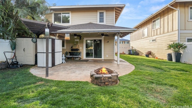 rear view of house featuring a lawn, a patio area, ceiling fan, and an outdoor fire pit