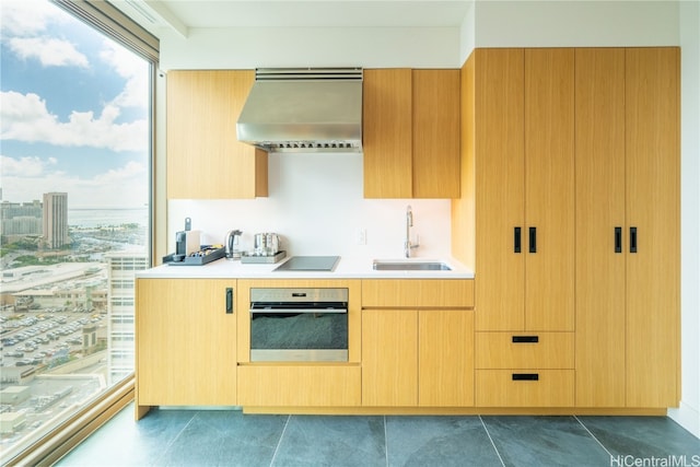 kitchen with oven, black electric cooktop, sink, and extractor fan