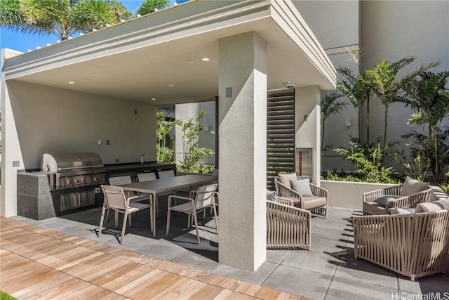 view of patio featuring an outdoor kitchen, sink, and grilling area