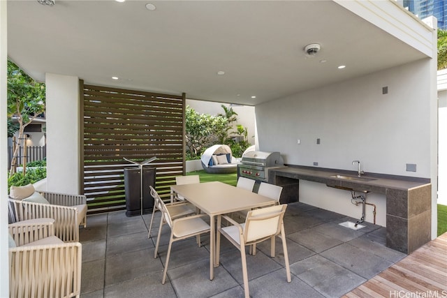 view of patio / terrace featuring grilling area, sink, and area for grilling