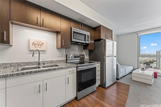 kitchen with decorative backsplash, sink, and stainless steel appliances