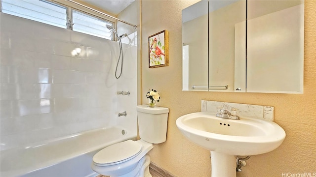 bathroom with toilet and bathing tub / shower combination