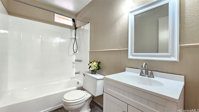 full bathroom with a textured ceiling, vanity, shower / bath combination, and toilet