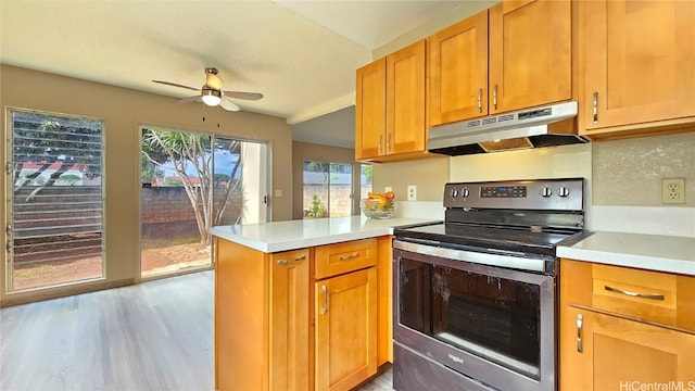 kitchen with kitchen peninsula, electric range, light hardwood / wood-style flooring, and ceiling fan