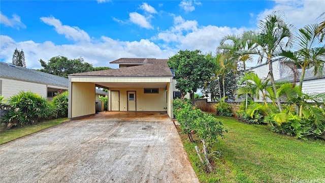 exterior space with a lawn and a carport