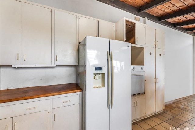 kitchen with wood ceiling, beam ceiling, light tile patterned floors, white cabinetry, and white appliances