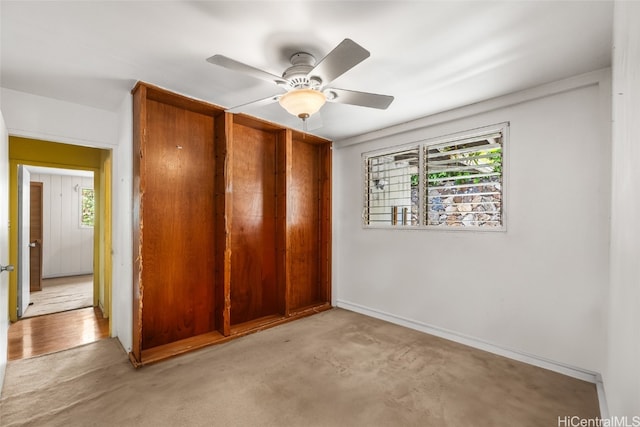 unfurnished bedroom featuring ceiling fan and light colored carpet