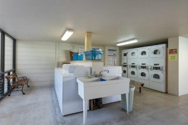 washroom with stacked washing maching and dryer and washer and dryer