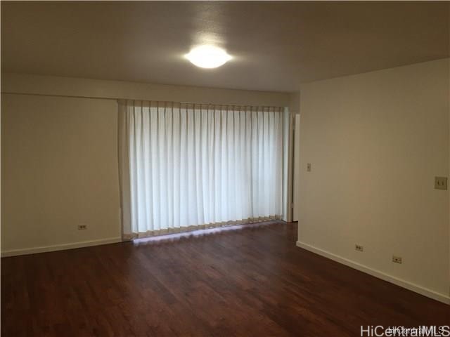 empty room with dark wood-type flooring