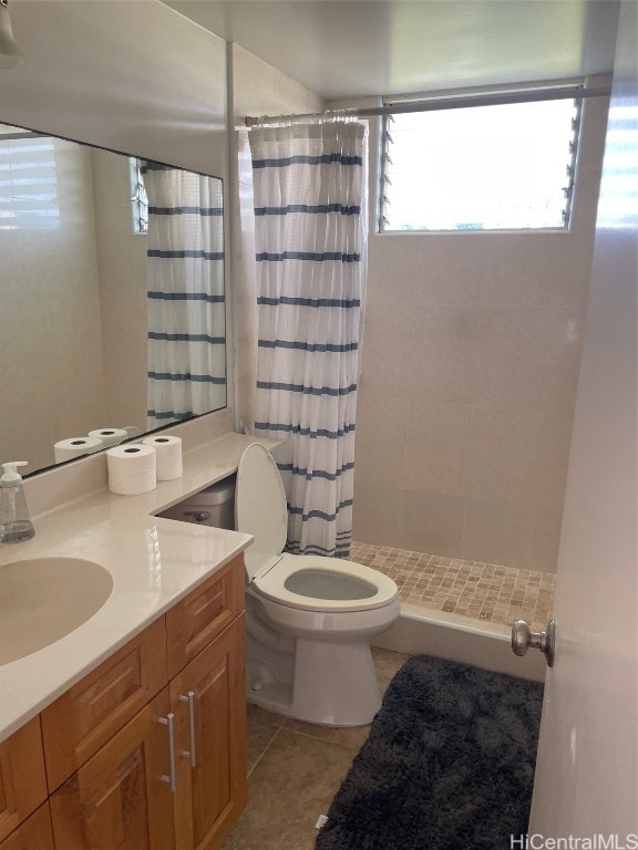 bathroom featuring toilet, vanity, tile patterned floors, and a shower with shower curtain