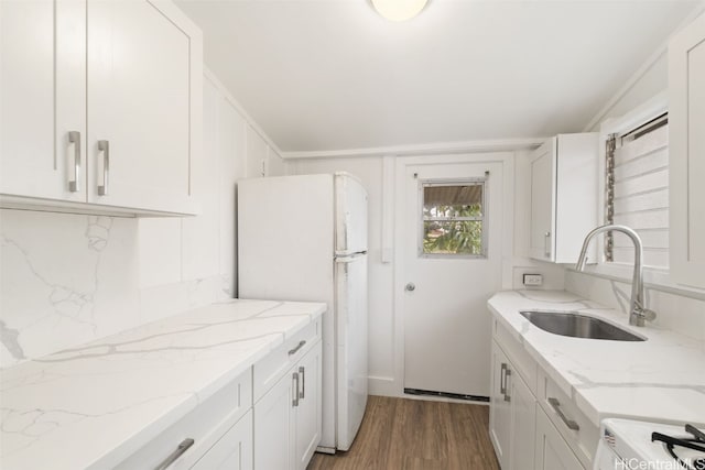 kitchen with white cabinets, white appliances, and sink