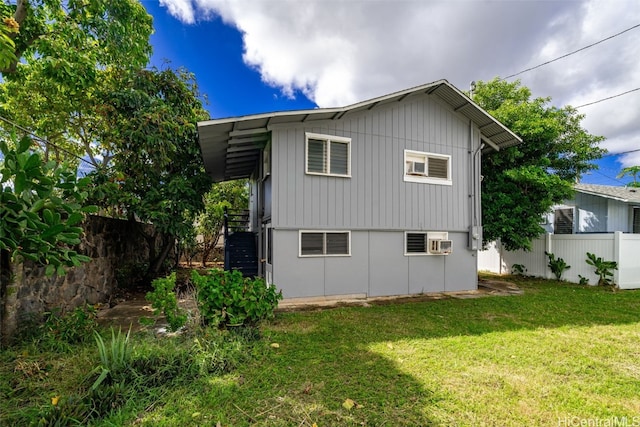 view of side of property with a lawn