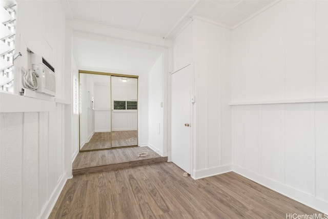 hallway with hardwood / wood-style flooring