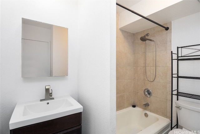 full bathroom featuring vanity, toilet, and tiled shower / bath