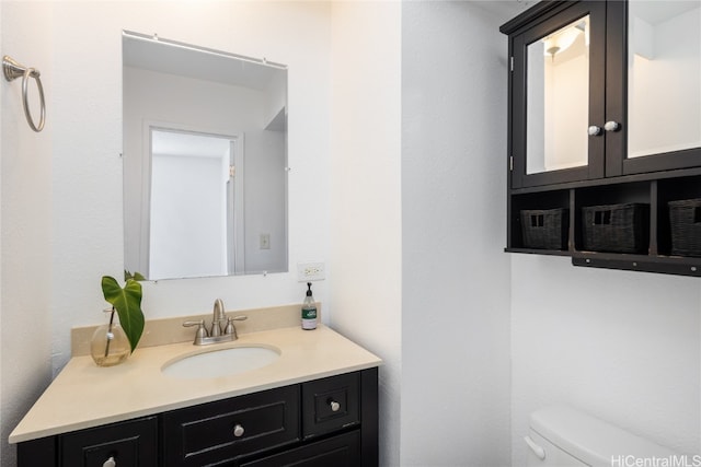 bathroom with toilet and vanity