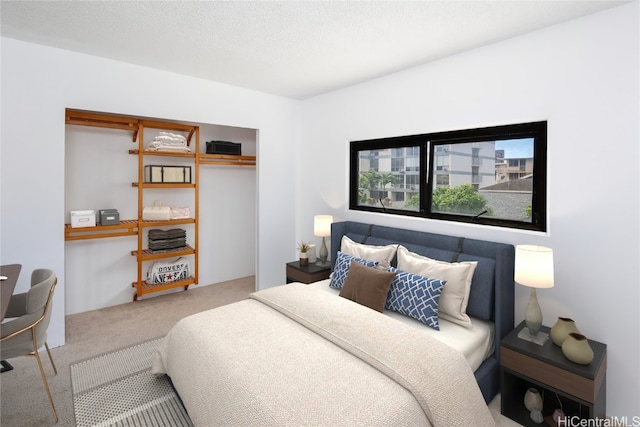 carpeted bedroom featuring a textured ceiling