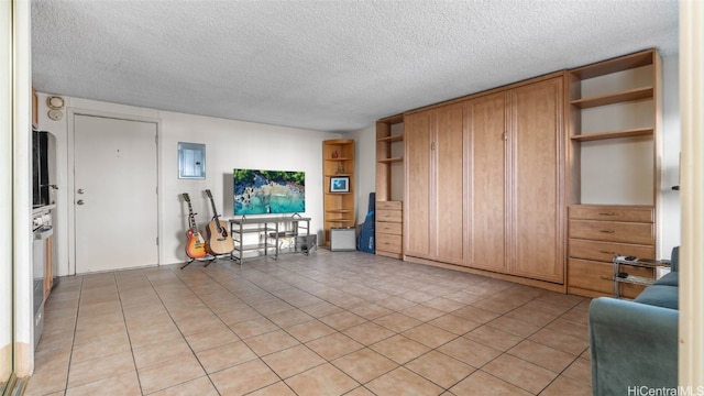 tiled living room featuring a textured ceiling