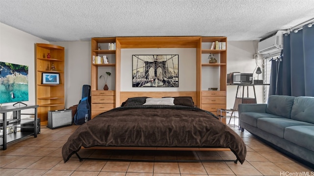 tiled bedroom with a textured ceiling and a wall mounted air conditioner