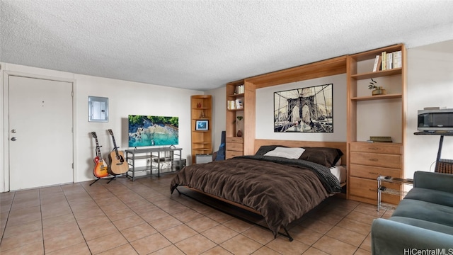 tiled bedroom featuring a textured ceiling