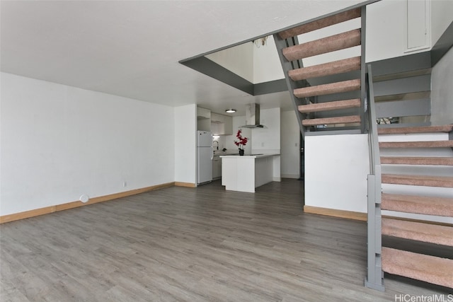 unfurnished living room with hardwood / wood-style flooring