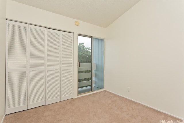 unfurnished bedroom featuring light colored carpet and a closet