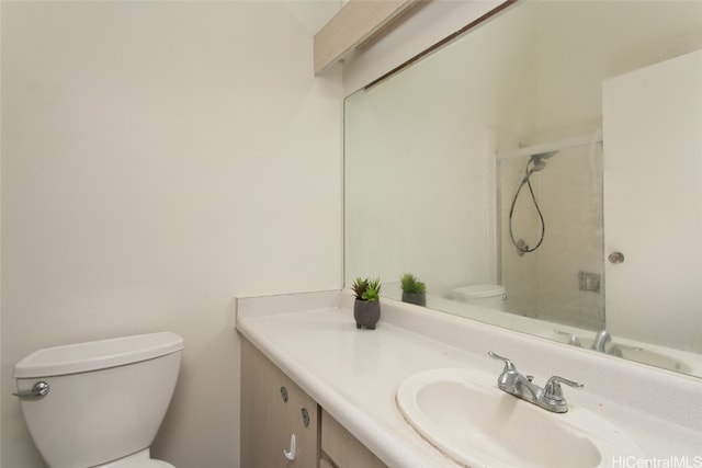 bathroom with a shower, vanity, and toilet