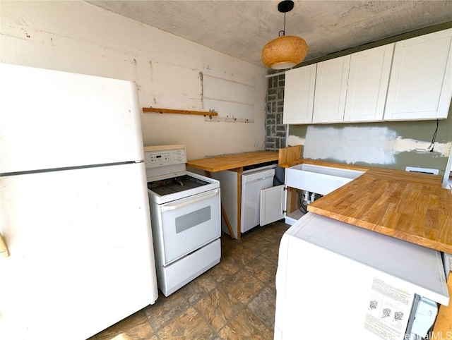 kitchen with white appliances, butcher block counters, pendant lighting, and white cabinets