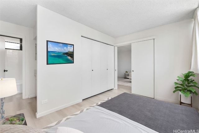 bedroom featuring a textured ceiling and light hardwood / wood-style floors