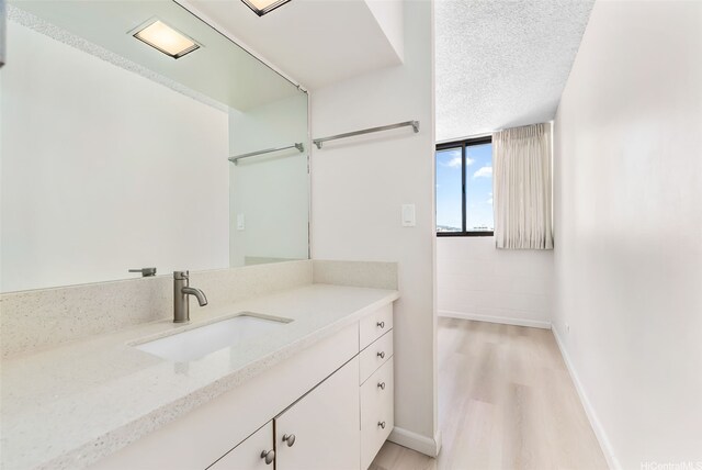 1040 Kinau St Unit 704, Honolulu, HI 96814 - bathroom with wood finished floors, baseboards, and vanity