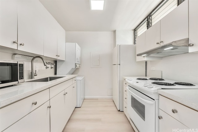 kitchen featuring light hardwood / wood-style floors, white cabinets, sink, and white appliances