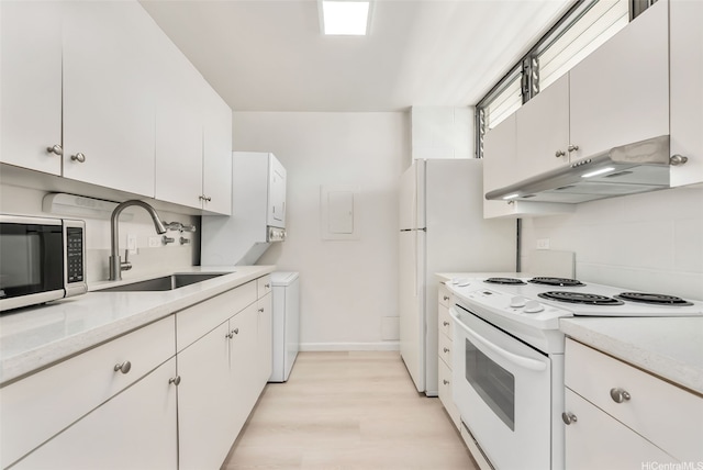 1040 Kinau St Unit 704, Honolulu, HI 96814 - kitchen featuring white appliances, under cabinet range hood, a sink, light countertops, and light wood finished floors