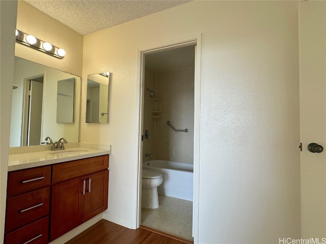 full bathroom with bathtub / shower combination, a textured ceiling, wood-type flooring, toilet, and vanity