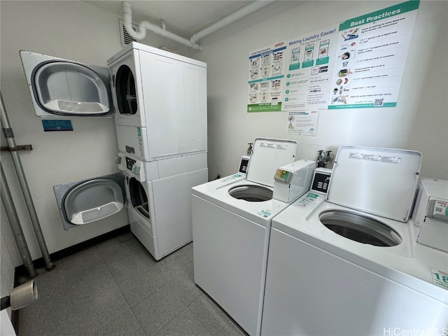 laundry area with stacked washer / drying machine and washing machine and clothes dryer